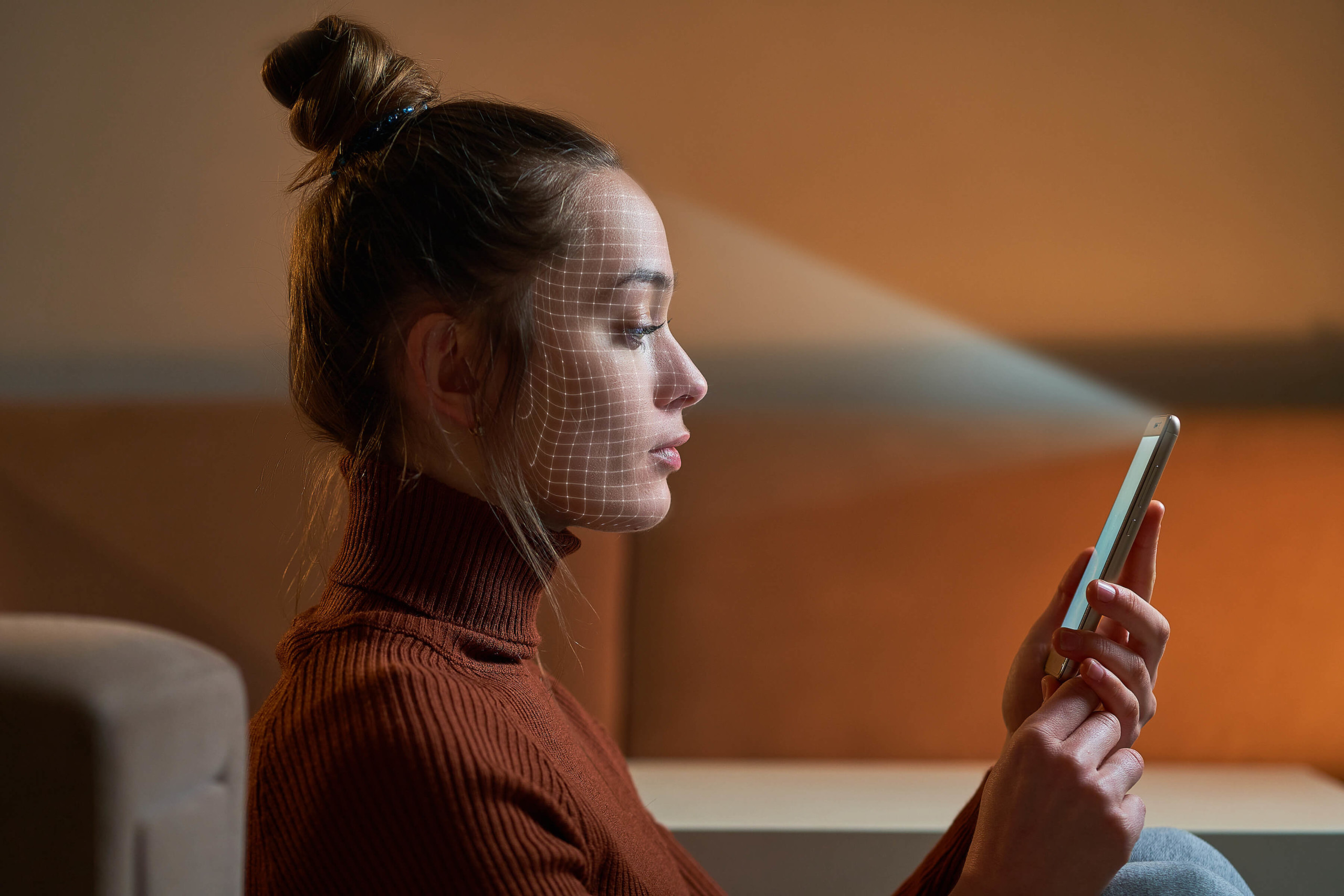 Woman using face biometrics on smartphone