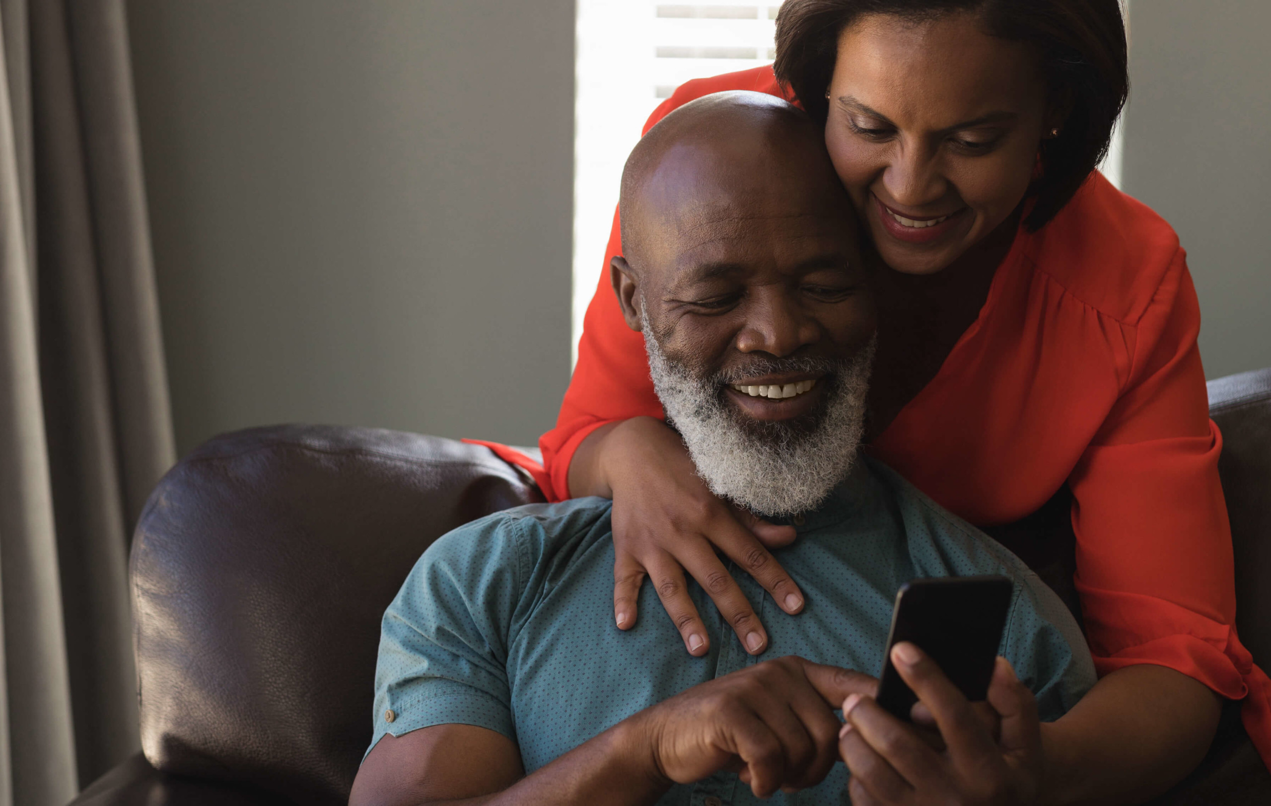 Senior couple using IdentityX on a smartphone
